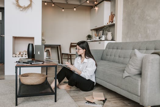 a woman working on her laptop in a cozy space